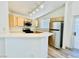 Open kitchen features stainless steel appliances and wood floors at 1881 W Alexander Rd # 2117, North Las Vegas, NV 89032