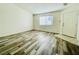 Spacious living room features wood laminate floors and a window at 1881 W Alexander Rd # 2117, North Las Vegas, NV 89032