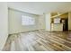 Open living room features wood laminate floors and lots of natural light at 1881 W Alexander Rd # 2117, North Las Vegas, NV 89032