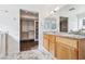 Bathroom featuring double sinks, granite countertops, and walk-in closet at 1911 Hobson Dr, Henderson, NV 89074