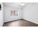 Bedroom with wood floors and a large window overlooking the neighborhood at 1911 Hobson Dr, Henderson, NV 89074