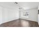 Bedroom with wood floors, ceiling fan, and large window at 1911 Hobson Dr, Henderson, NV 89074