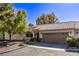 Charming single-story home featuring a tile roof, two-car garage, and mature landscaping at 1911 Hobson Dr, Henderson, NV 89074
