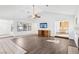 Bright living room featuring a fireplace, ceiling fan, and views into kitchen at 1911 Hobson Dr, Henderson, NV 89074
