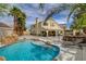 Spacious backyard with a pool, rock features, patio, and landscaped areas at 2073 Sapphire Valley Ave, Henderson, NV 89074