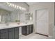 Main bathroom featuring a double vanity, soaking tub, and walk-in shower at 2073 Sapphire Valley Ave, Henderson, NV 89074