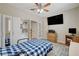 Bright bedroom features a mounted television, built-in shelving, and view through doorway at 2073 Sapphire Valley Ave, Henderson, NV 89074