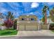 Charming two-story home featuring a desert landscape, two-car garage, and arched windows at 2073 Sapphire Valley Ave, Henderson, NV 89074