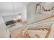 Bright living room with wood floors, stylish staircase, gray sofa and modern chandelier at 2073 Sapphire Valley Ave, Henderson, NV 89074