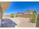 The cozy backyard has desert landscaping, is fully fenced, and has a brick patio at 2300 Sky Island Dr, Henderson, NV 89002