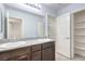 Bathroom features dual sinks with granite countertop and dark wood cabinets, shower, and linen closet at 2300 Sky Island Dr, Henderson, NV 89002
