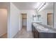 Bathroom featuring a double vanity with granite countertop and a walk in closet at 2300 Sky Island Dr, Henderson, NV 89002