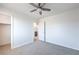 Bright bedroom features neutral paint, carpet, ceiling fan, and a closet, offering a simple design at 2300 Sky Island Dr, Henderson, NV 89002