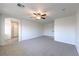 Large bedroom with neutral carpet, ceiling fan, and bright natural light at 2300 Sky Island Dr, Henderson, NV 89002