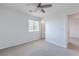 Bright bedroom features neutral paint, carpet, ceiling fan, and a closet, offering a simple design at 2300 Sky Island Dr, Henderson, NV 89002