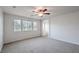 Bright bedroom with large windows, neutral carpet, and access to the bathroom at 2300 Sky Island Dr, Henderson, NV 89002