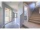 Neutral entryway featuring stairway, tiled floors, leading to a bathroom and backyard access at 2300 Sky Island Dr, Henderson, NV 89002