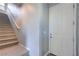 Bright entryway featuring a staircase with carpeted steps and a white front door at 2300 Sky Island Dr, Henderson, NV 89002
