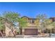 Charming two-story home featuring a two-car garage and desert landscaping in front at 2300 Sky Island Dr, Henderson, NV 89002