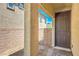 Inviting front entrance with a solid door, brick accents, and tiled welcome mat at 2300 Sky Island Dr, Henderson, NV 89002