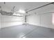 Spacious garage with overhead racks for ample storage and epoxy flooring at 2300 Sky Island Dr, Henderson, NV 89002