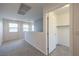 Bright hallway featuring neutral paint, carpet, and a doorway to a closet, offering a simple design at 2300 Sky Island Dr, Henderson, NV 89002