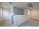 Upstairs hallway with carpet flooring, neutral color scheme, and white banister at 2300 Sky Island Dr, Henderson, NV 89002