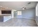Open-concept living room with tiled floors, ceiling fan, and a view into the kitchen at 2300 Sky Island Dr, Henderson, NV 89002