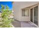 Backyard with brick patio, desert landscaping, window, and glass sliding door at 2300 Sky Island Dr, Henderson, NV 89002