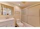 Bright bathroom with vanity, toilet, and shower featuring a glass sliding door at 2352 Pickwick Dr # 85, Henderson, NV 89014