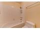 Clean tiled bathtub with mounted shower head, toiletry rack, and a standard toilet at 2352 Pickwick Dr # 85, Henderson, NV 89014