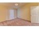 Bright bedroom featuring neutral carpet, vertical blinds, and a ceiling fan with integrated lighting at 2352 Pickwick Dr # 85, Henderson, NV 89014