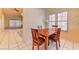 Cozy dining area with a wood table and view into the living space and sliding glass door at 2352 Pickwick Dr # 85, Henderson, NV 89014