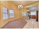 Dining area featuring large windows, carpet, tile flooring, and a decorative light fixture at 2352 Pickwick Dr # 85, Henderson, NV 89014