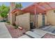 Townhouse exterior with a private patio area, pergola, gated entrance and AC unit at 2352 Pickwick Dr # 85, Henderson, NV 89014