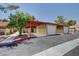 Exterior shot of attached garages and carports for townhouses with desert landscaping at 2352 Pickwick Dr # 85, Henderson, NV 89014