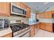 Modern kitchen appliances, including a gas stove, microwave, and stainless steel dishwasher at 2352 Pickwick Dr # 85, Henderson, NV 89014
