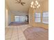 Open living room with neutral color palette and tile flooring near front and carpet in the back, as well as a modern light fixture at 2352 Pickwick Dr # 85, Henderson, NV 89014