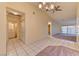Spacious living room featuring tile flooring, access to the backyard, and a modern ceiling fan at 2352 Pickwick Dr # 85, Henderson, NV 89014