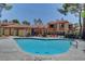 Community pool with lounge chairs surrounded by townhouses and mature trees at 2352 Pickwick Dr # 85, Henderson, NV 89014