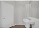 Bright bathroom featuring a pedestal sink, tiled floors, and modern fixtures at 2405 Esteem Ridge Dr, Henderson, NV 89052