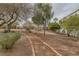 Beautiful community green space featuring walking trails, various bushes, and mature trees at 2405 Esteem Ridge Dr, Henderson, NV 89052