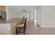 Open kitchen with bar seating, stainless steel appliances, and tiled floors at 2405 Esteem Ridge Dr, Henderson, NV 89052