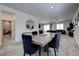 Elegant dining area featuring a large table, contemporary decor, and a view of the adjacent living space at 242 Polaris Ridge Ave, Henderson, NV 89011