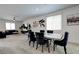 Spacious living room and dining area with plush carpeting and modern decor at 242 Polaris Ridge Ave, Henderson, NV 89011