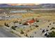 A sprawling desert property with a charming red-roofed home, complemented by drought-resistant landscaping and clear blue skies at 2801 Peggy Ave, Pahrump, NV 89048