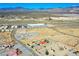 Aerial view of a red-roofed home surrounded by desert landscape with distant mountains on a sunny day at 2801 Peggy Ave, Pahrump, NV 89048