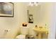 Bathroom with decorative mirror and sink; features classic fixtures and artwork at 2801 Peggy Ave, Pahrump, NV 89048