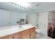 Well-lit bathroom features a vanity, toilet, shower with tub, and tile floors at 2983 Juniper Hills Blvd # 102, Las Vegas, NV 89142