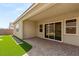 Relaxing backyard featuring artificial turf, a putting green, and a covered patio area at 3391 Stone View Ave, Henderson, NV 89044